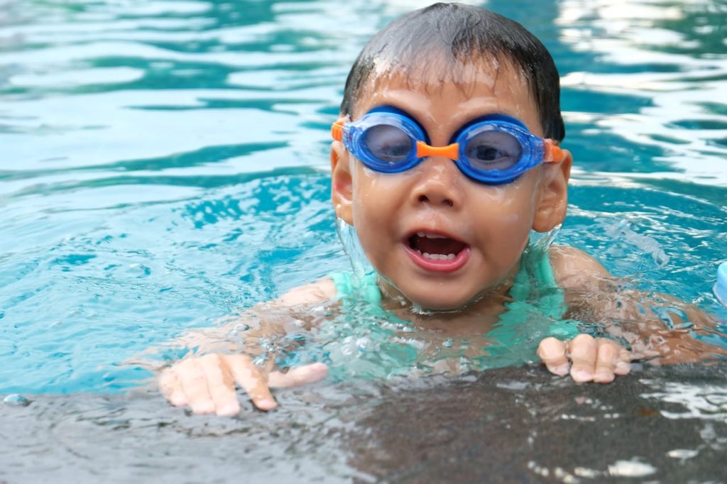 Mastering the First Impression: Your intriguing post title goes here Young child playing and swimming in a pool, enjoying the water.